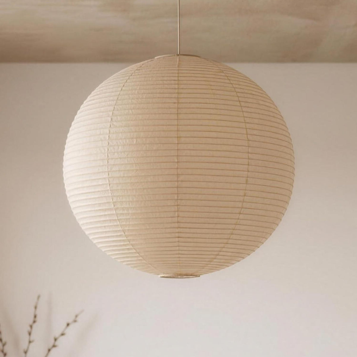 Pia pendant light, white washi paper globe, switched off under a pale concrete ceiling