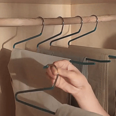 Sliding pants onto Z shape hangers from the open side on a closet rod