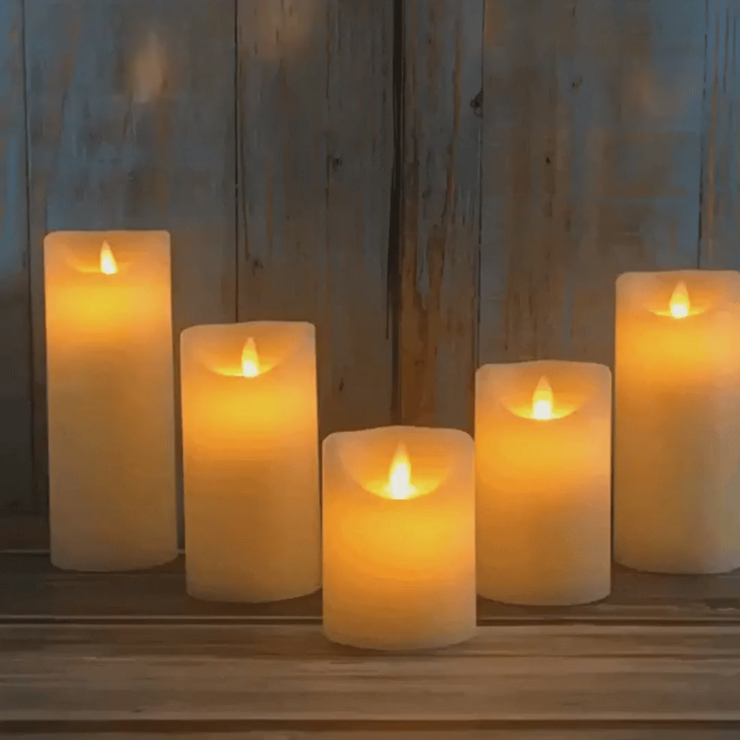 Flameless LED pillar candles flickering on a wooden shelf