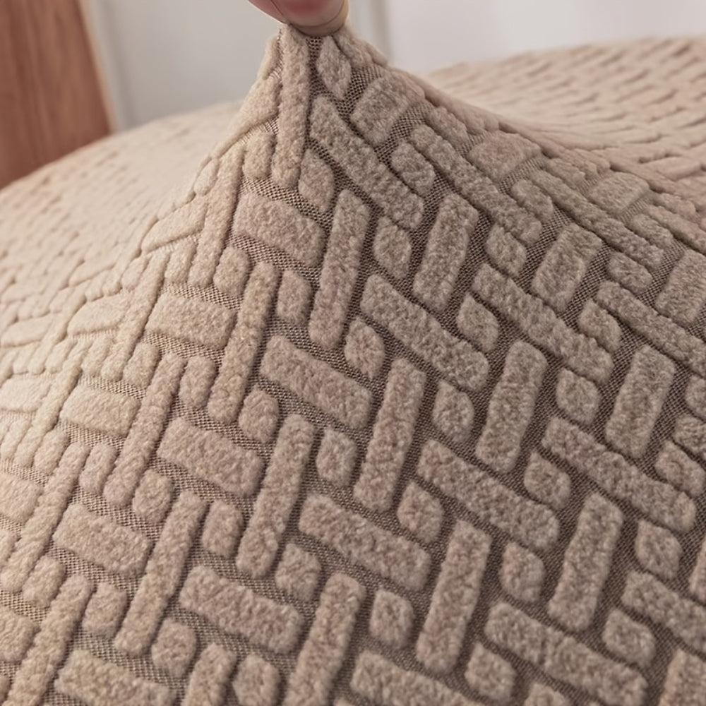 Close view of the knit surface of the taupe recliner cover being lifted at one corner