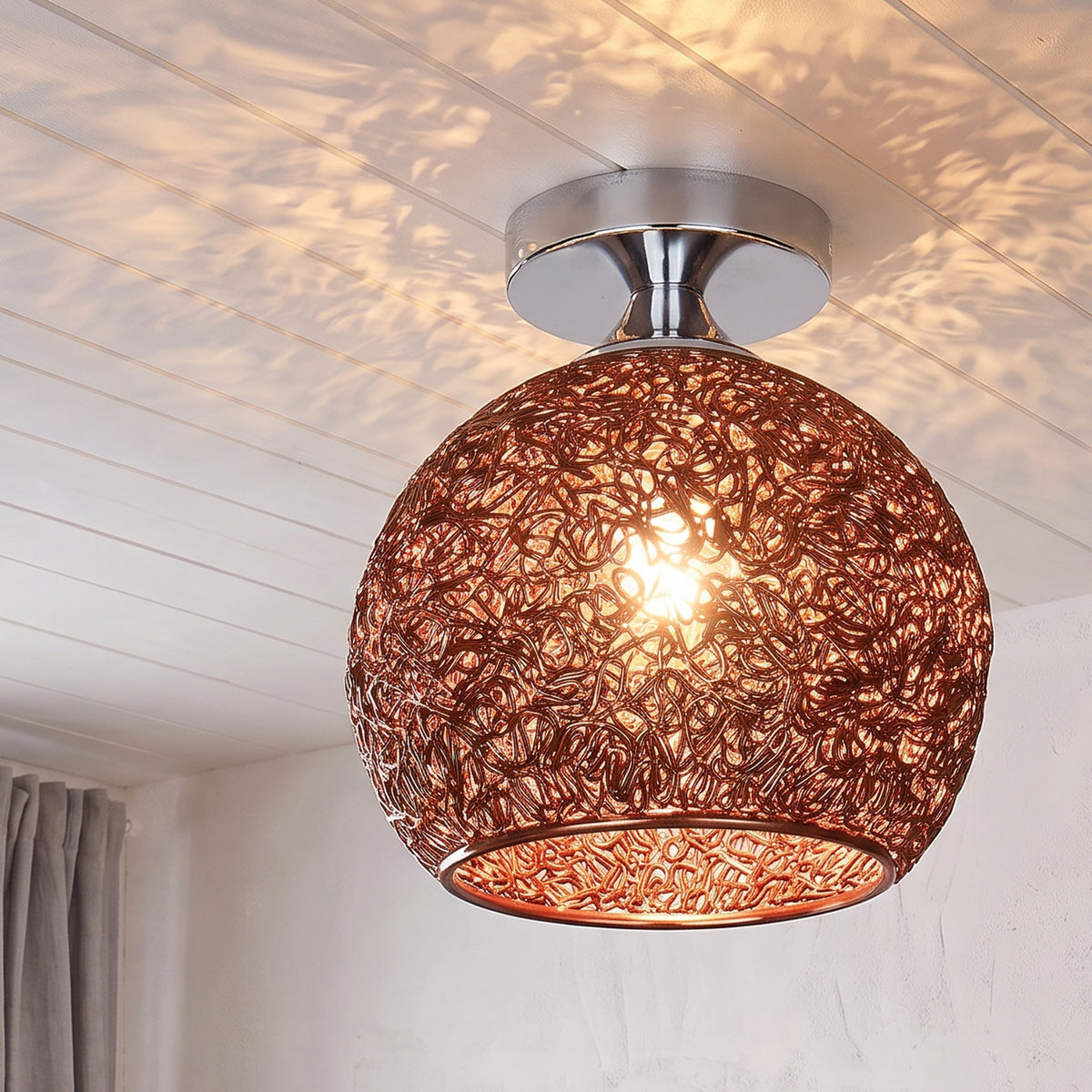 Brown Saara wire dome ceiling light lit in the same room