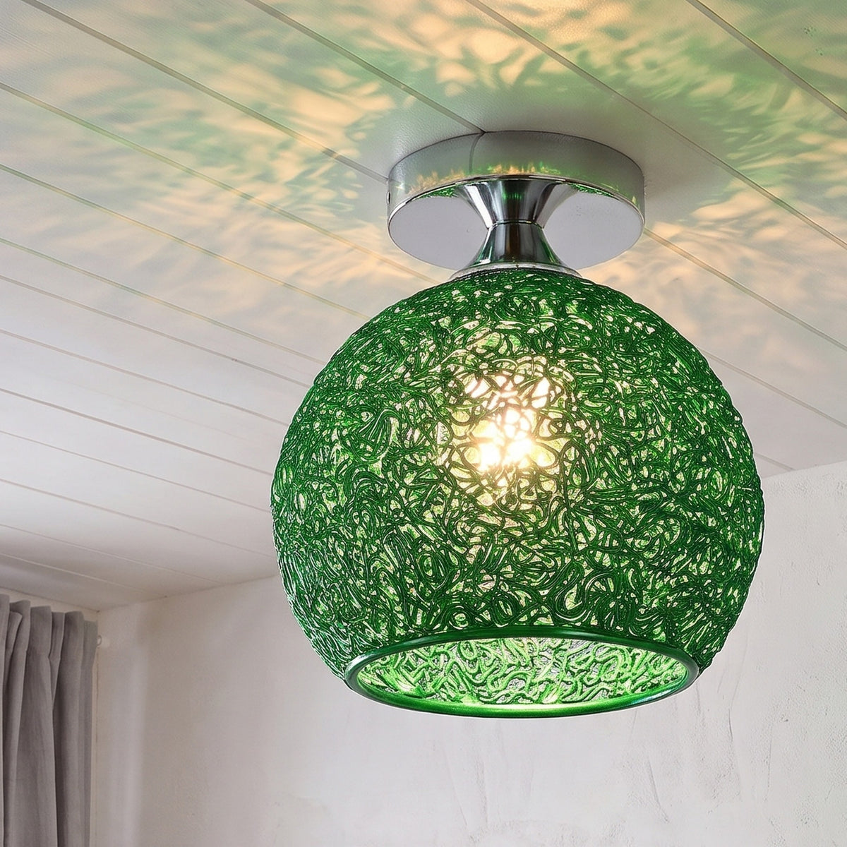 Green Saara wire dome ceiling light lit in the same room
