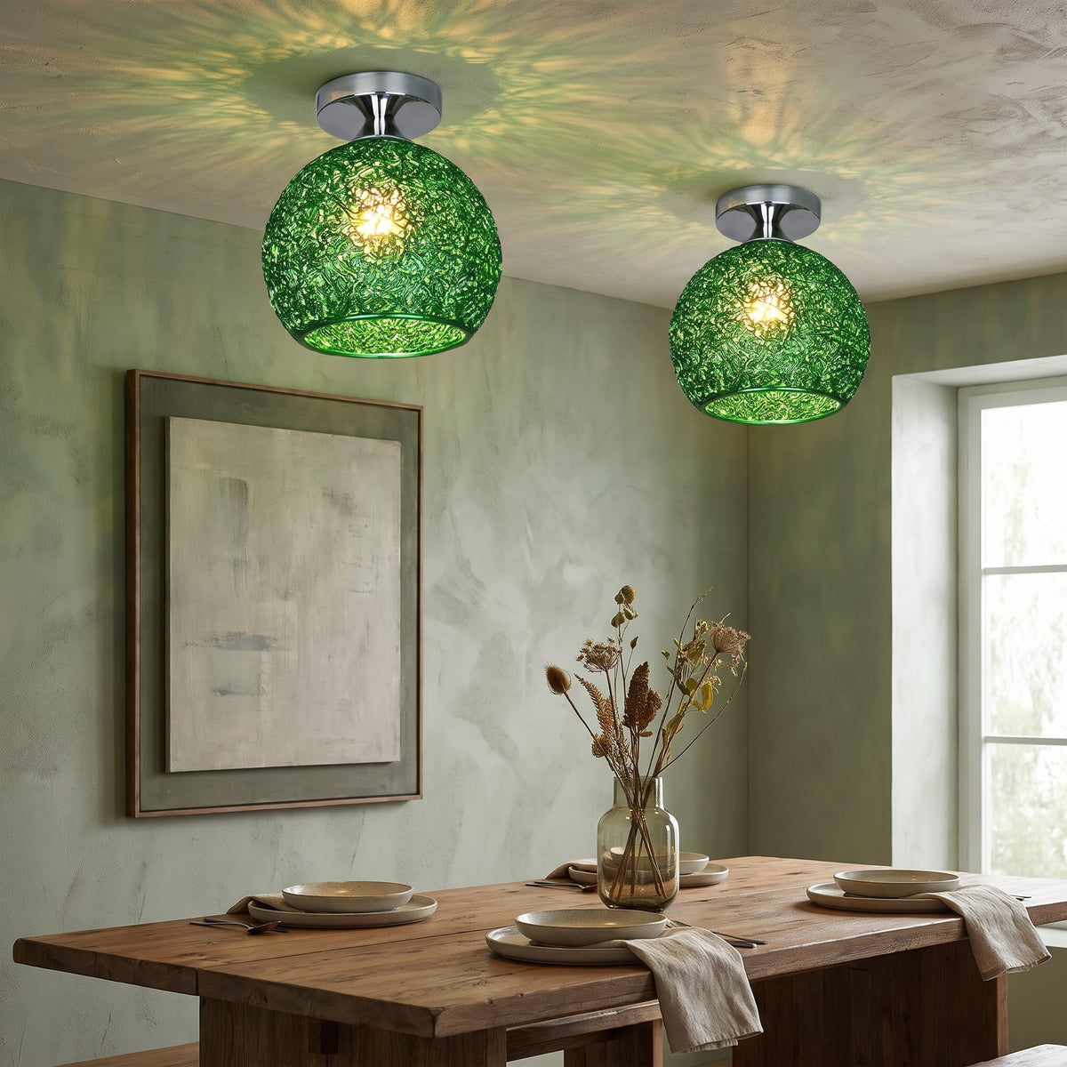 Two green Saara wire dome ceiling lights above a dining table