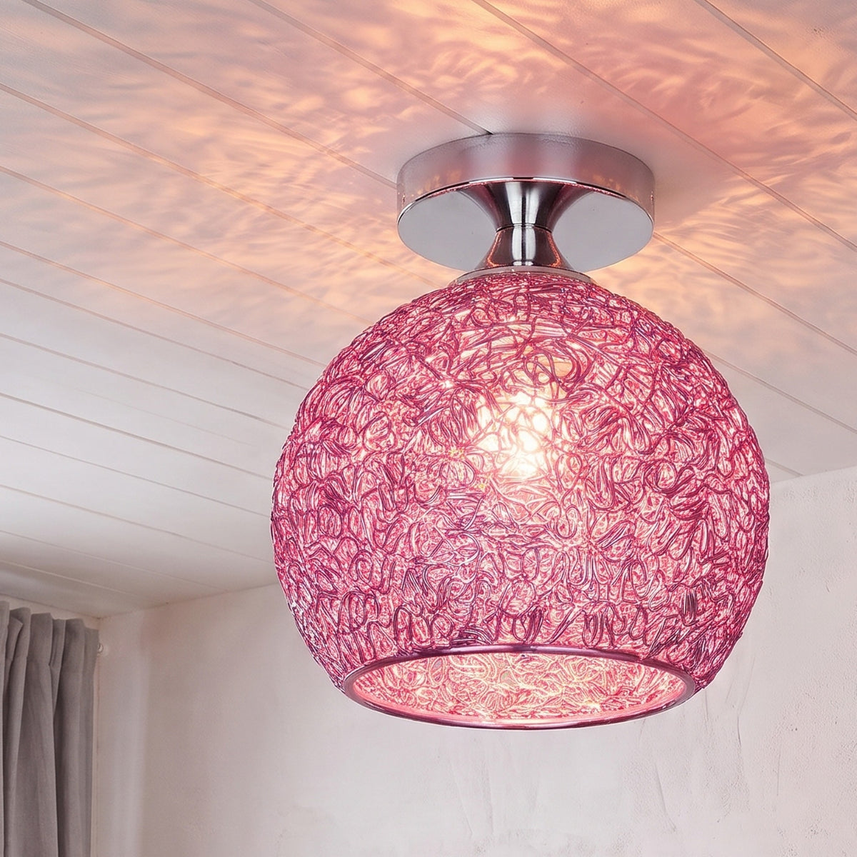 Pink Saara wire dome ceiling light lit in the same room