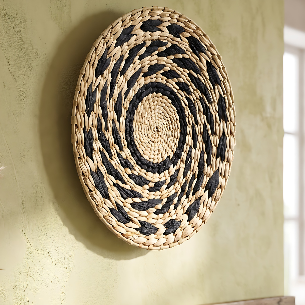 Sanne seagrass wall basket in Black Pattern, 11.8", on a warm white limewash wall
