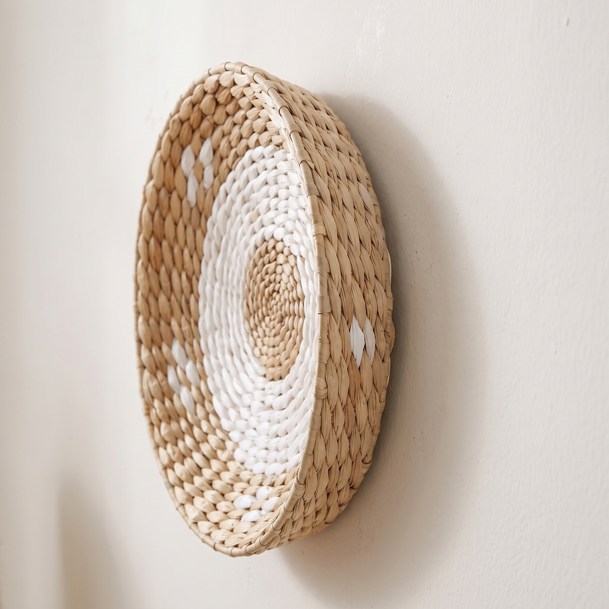 Side view of a seagrass wall basket showing its shallow depth and coiled weave