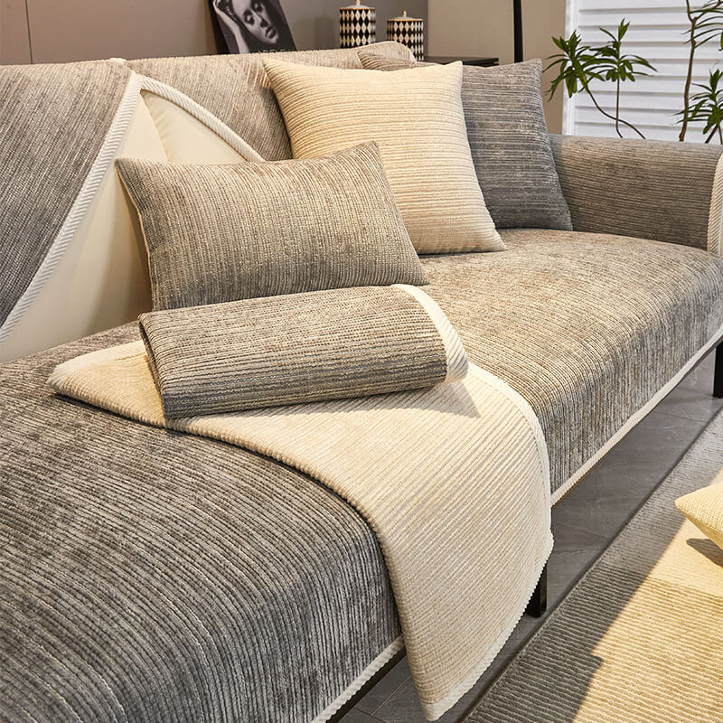 Taupe ribbed sofa cover with matching pillows on a sofa