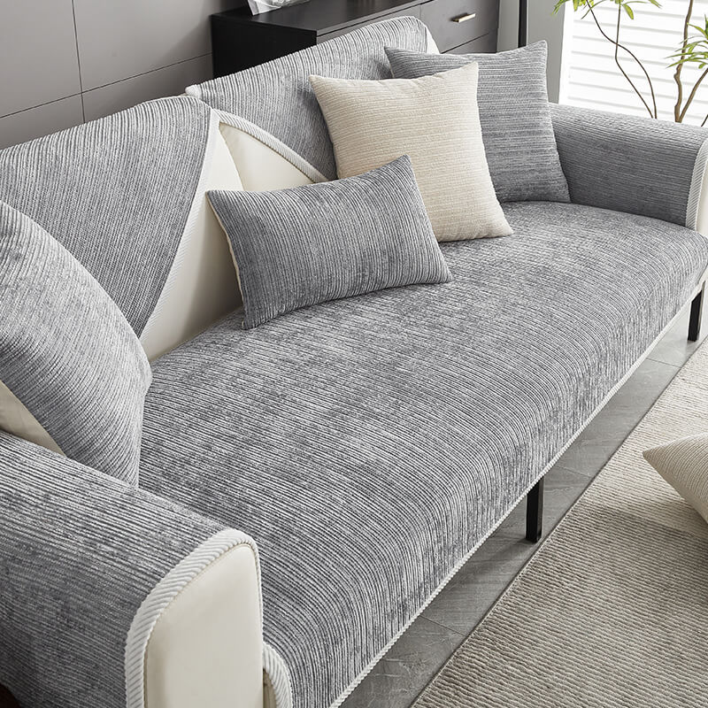 Gray ribbed sofa cover on a sofa with pillows