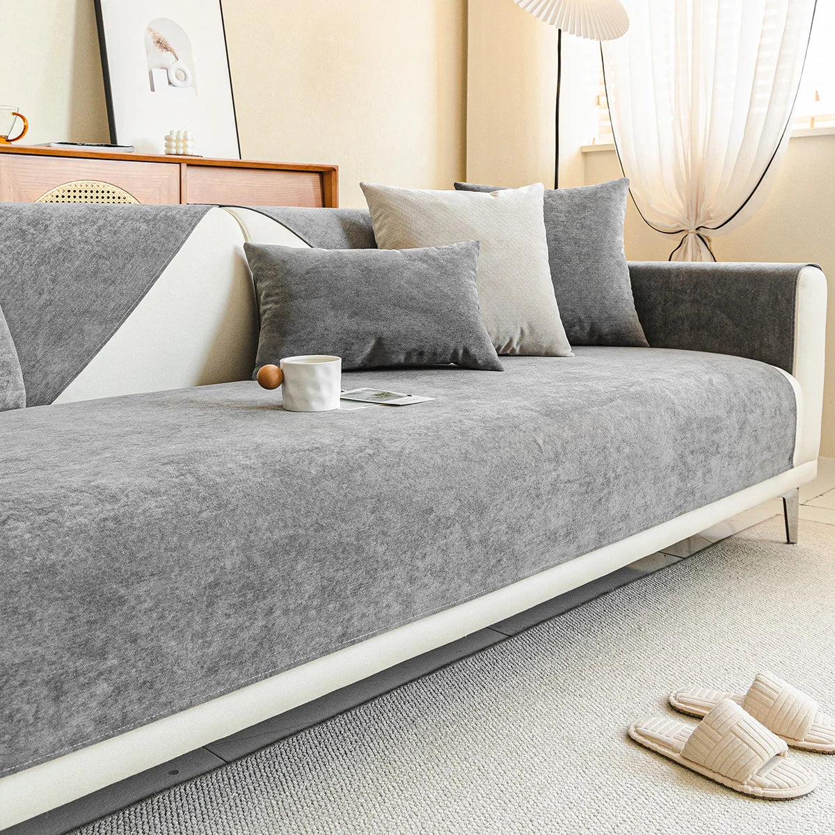 Gray ribbed sofa cover on a white sofa in a living room