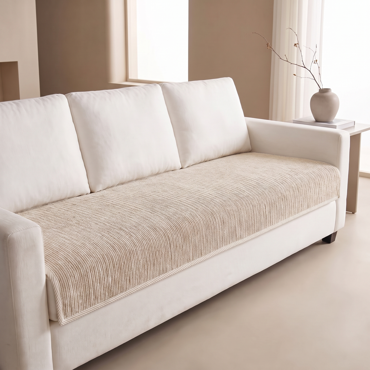 Beige ribbed sofa cover fitted over the seat of a white sofa