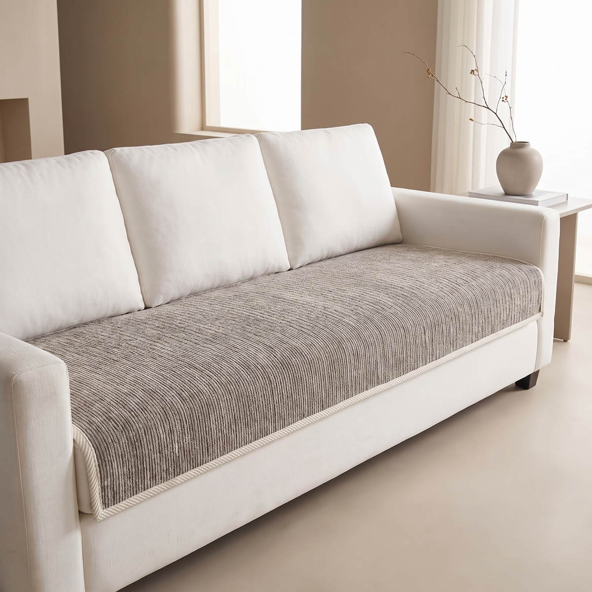 Taupe gray ribbed sofa cover fitted over the seat of a white sofa
