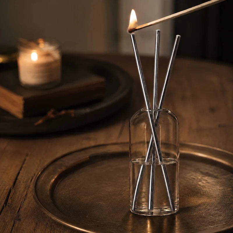 Lighting a Skive silver oil candle with a long match