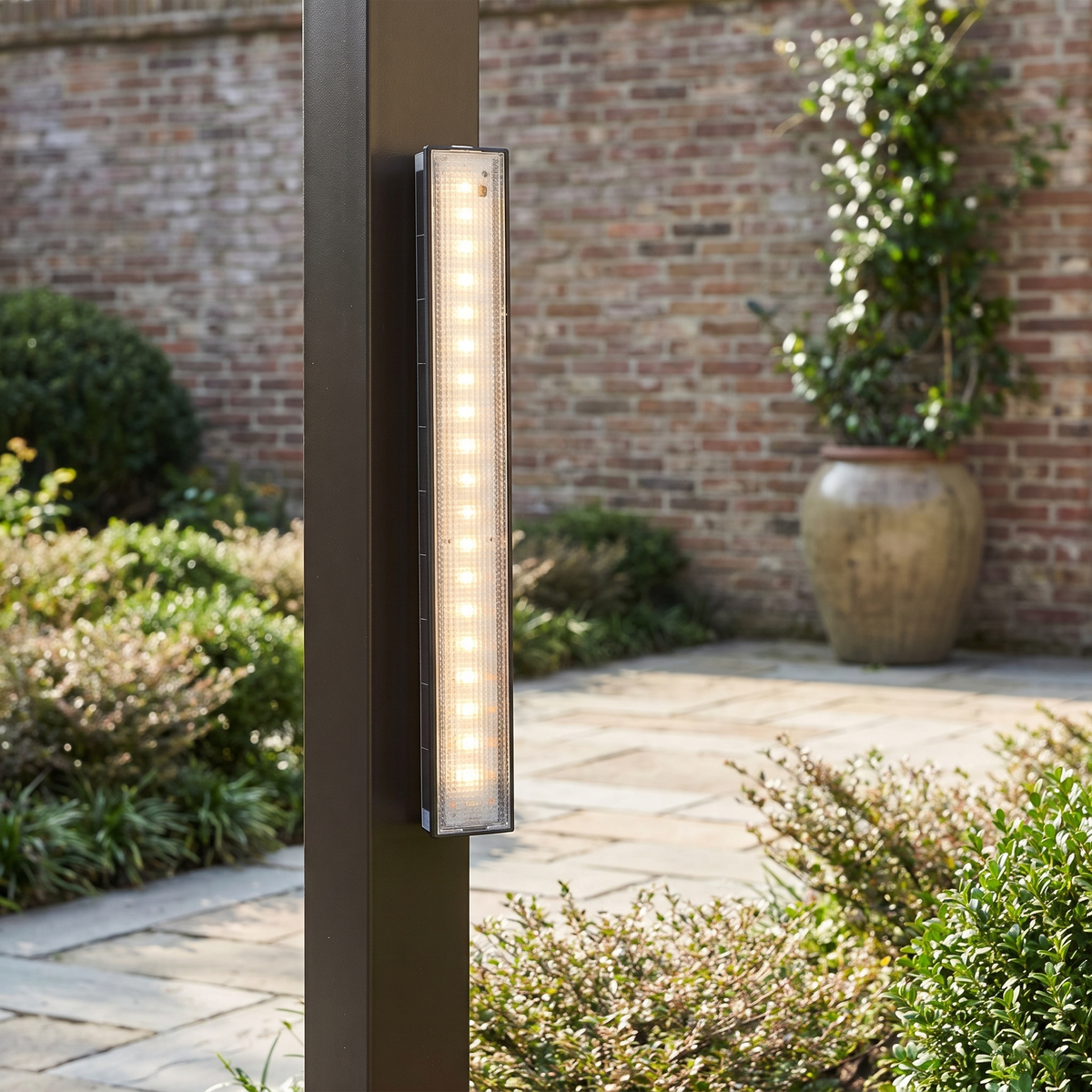 Solar wall light bar mounted upright on a garden post