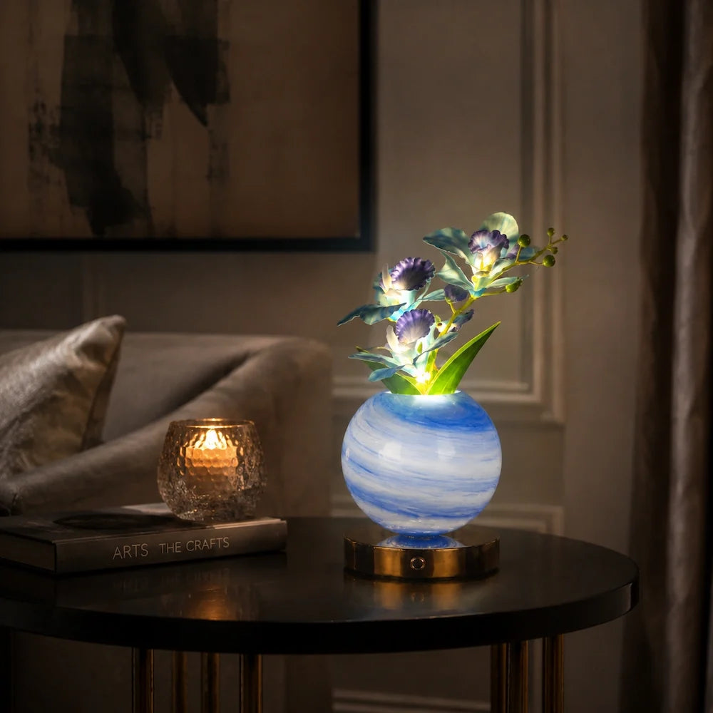 Solna orchid lamp in Azure lit on a dark side table