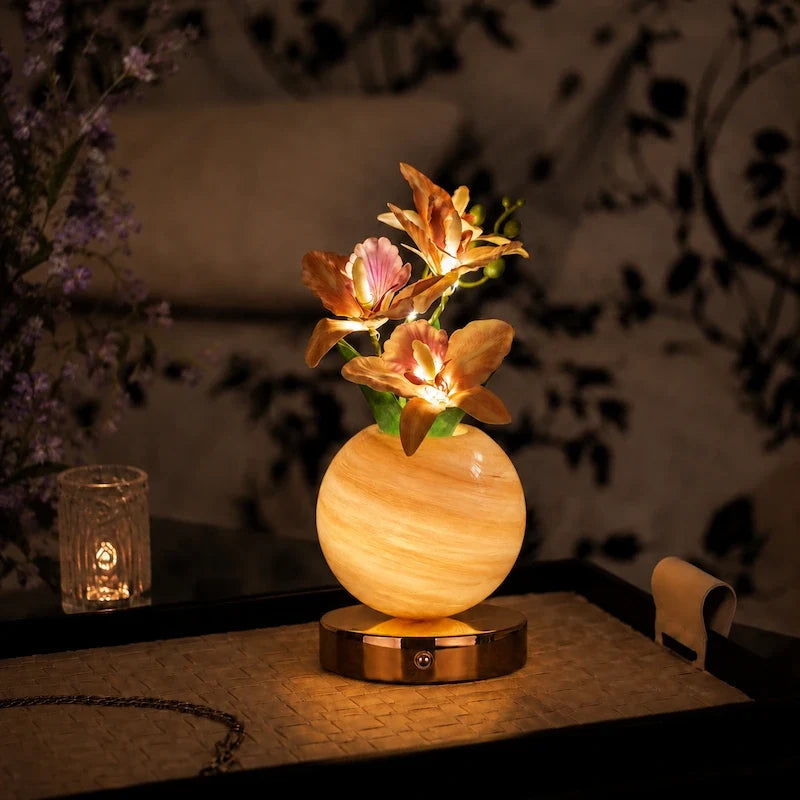 Solna orchid lamp in Champagne lit on a side table