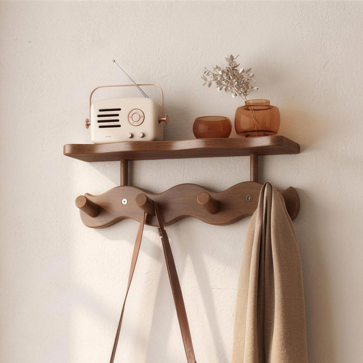 Sonja wall rack in brown with four bamboo pegs and one shelf on an entryway wall