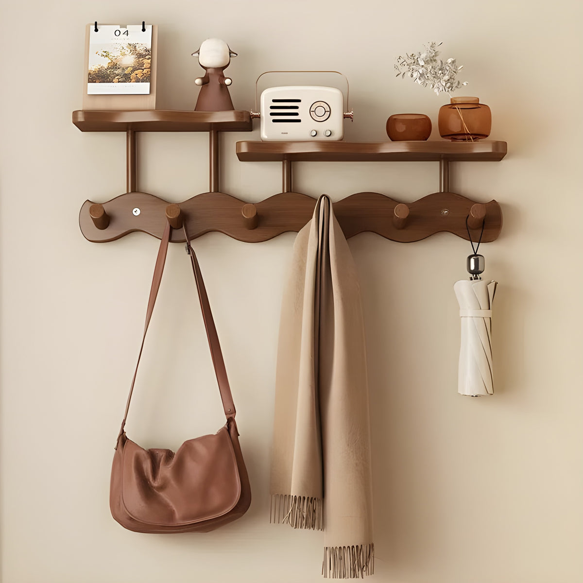 Sonja wall rack in brown with six pegs and two shelves holding a bag, a scarf and an umbrella