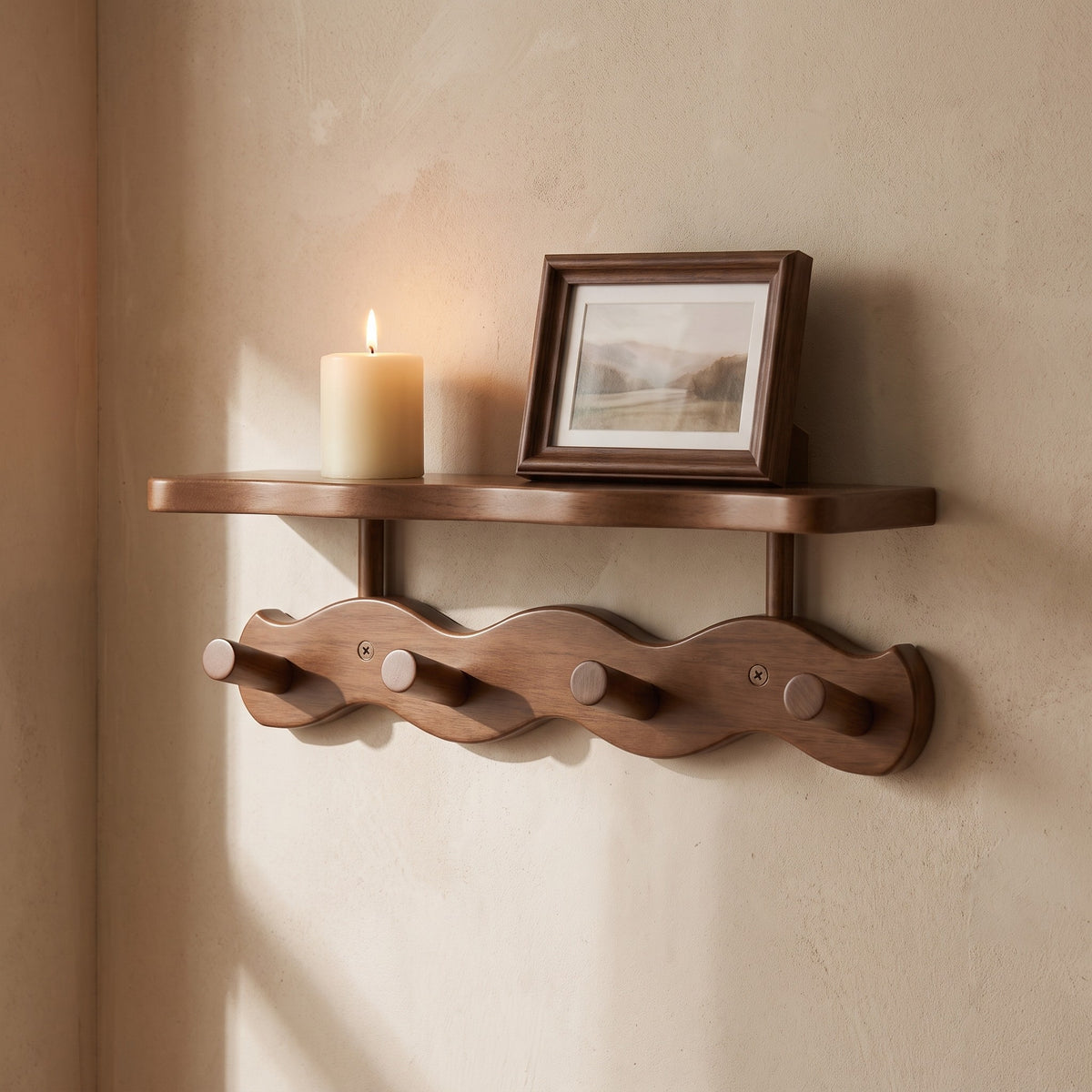 Shelf of the Sonja wall rack with a candle and a small frame