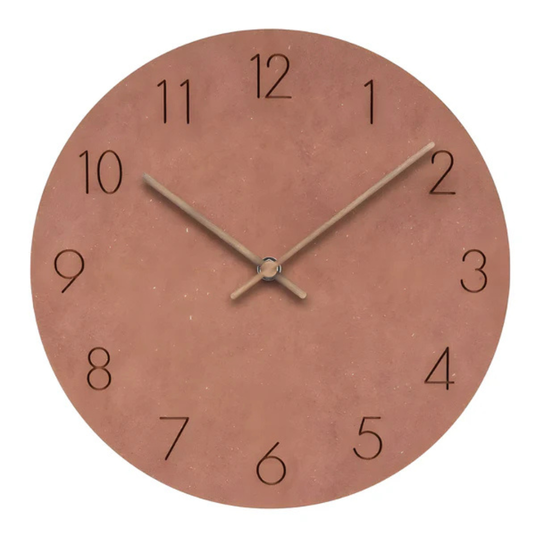 Terracotta dial wall clock with black numerals and wooden hands on a white background