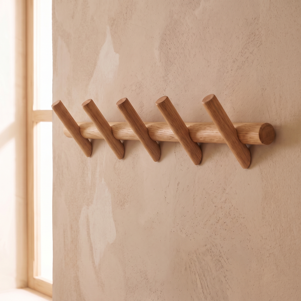 Close view of the Stord oak rail and pegs showing the grain under a clear matte finish