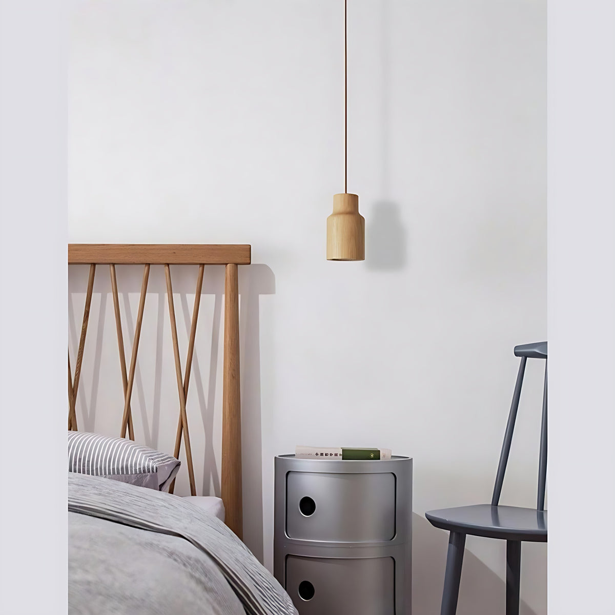 Svea wood pendant light, bottle shade, hanging beside a bed