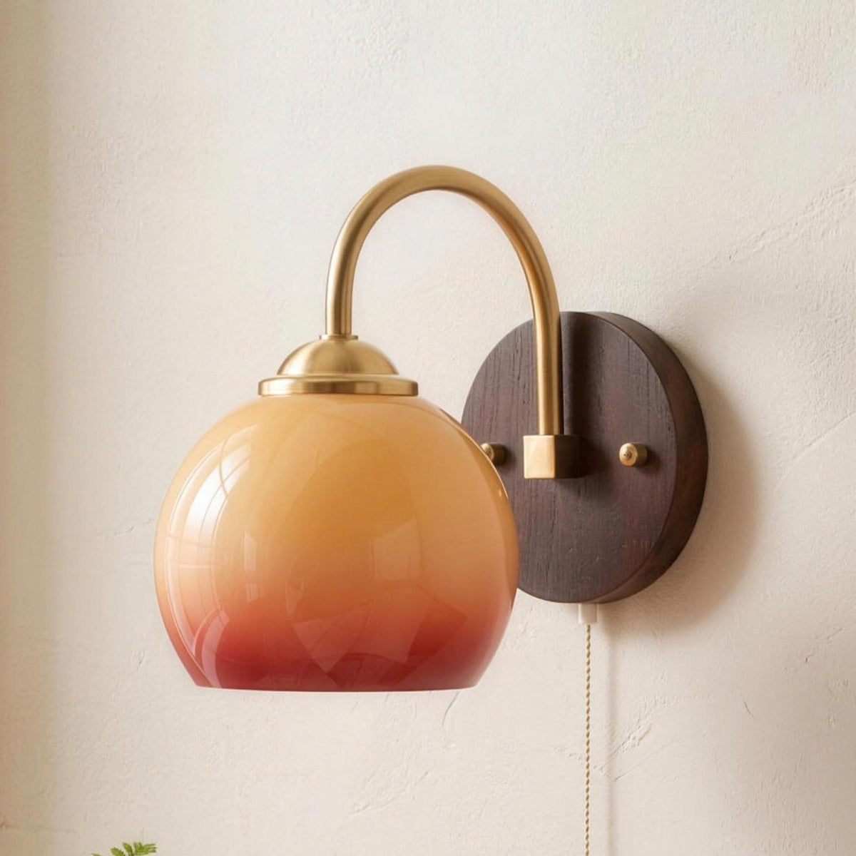 Stina wall sconce in Round Caramel above a bedside