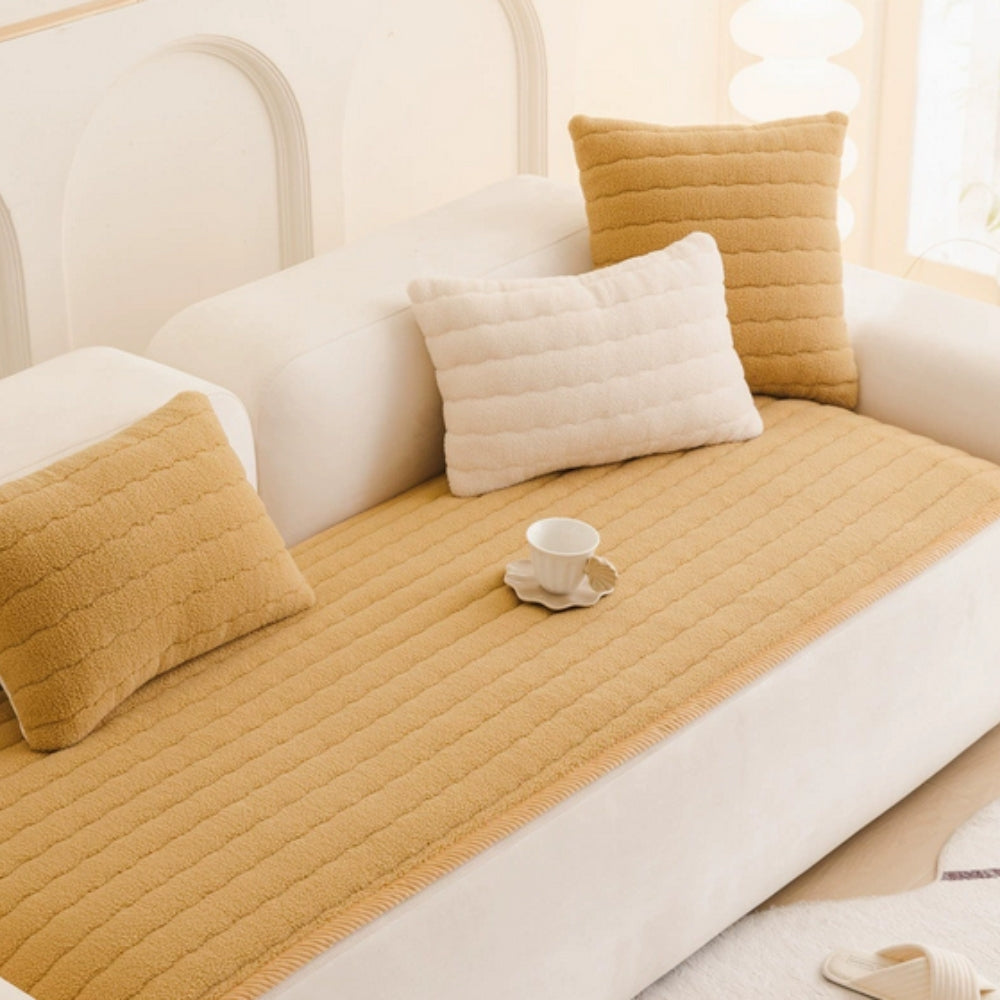 Honey quilted sofa cover on a white sofa with matching pillows