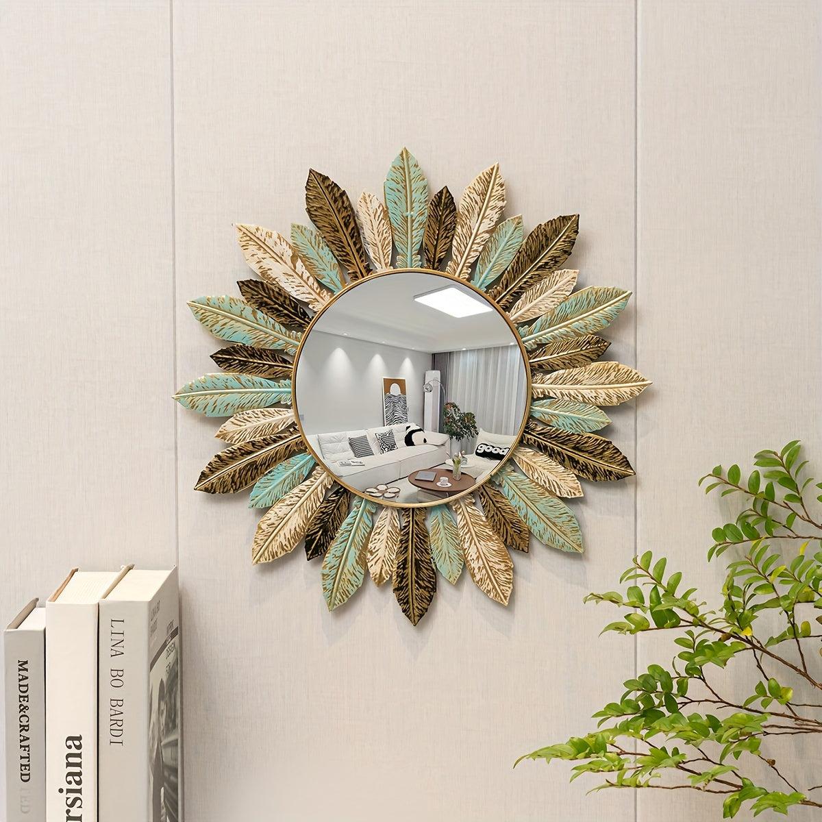 Tinn sunburst mirror on a paneled wall above a stack of books