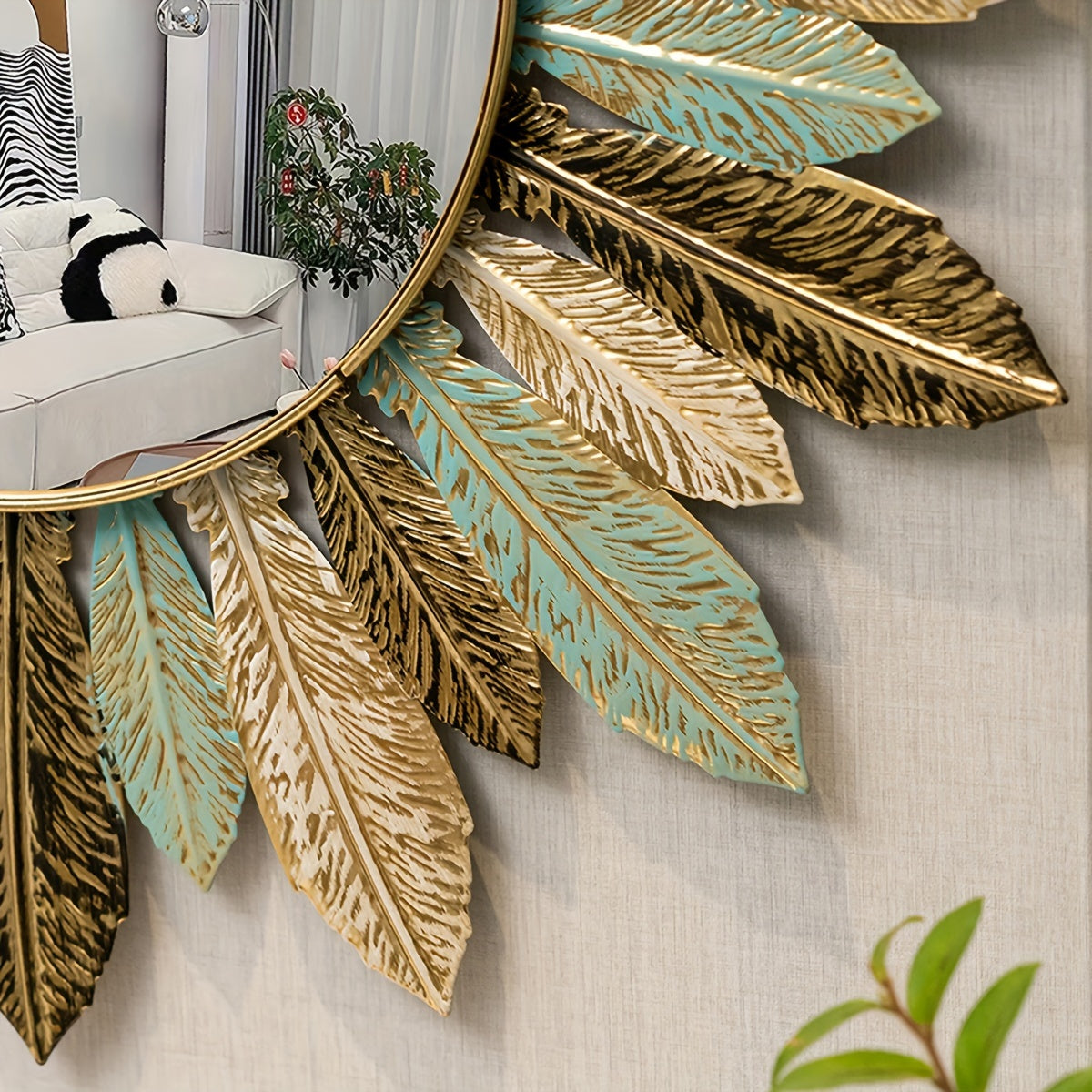 Detail of the teal and gold metal leaves around the Tinn mirror frame