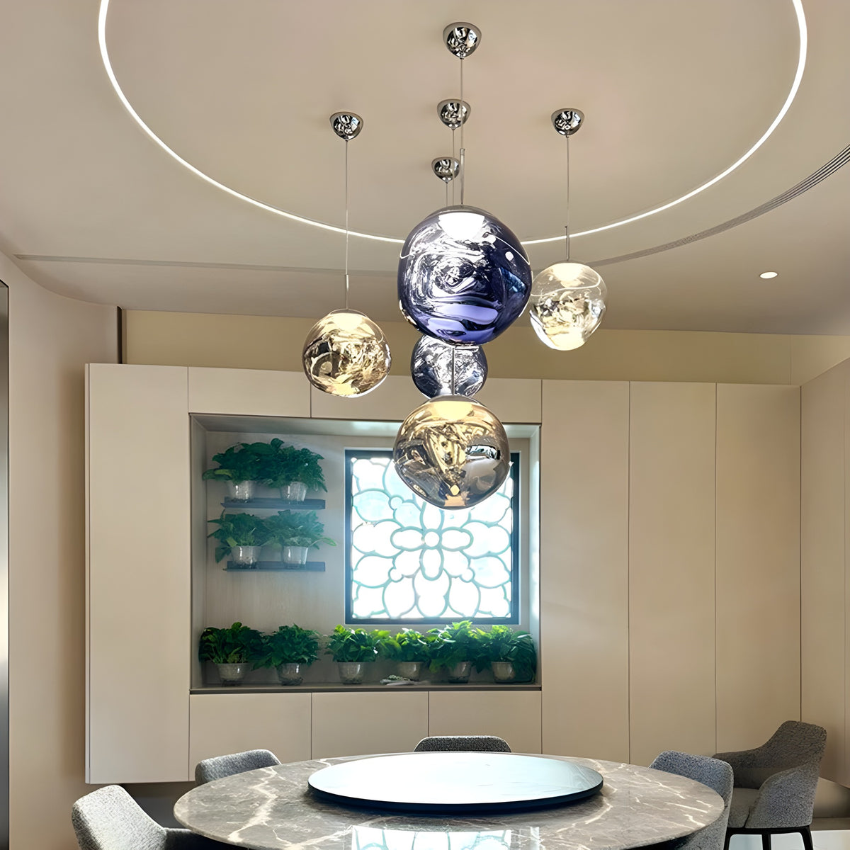 A cluster of Tora pendant lights over a round dining table