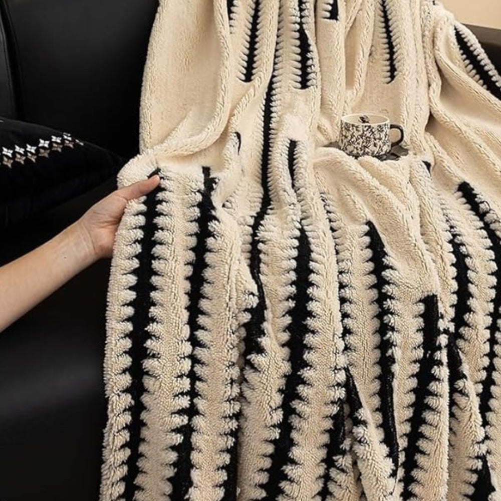Hand holding up the ivory tufted cover to show its thick pile and how it hangs