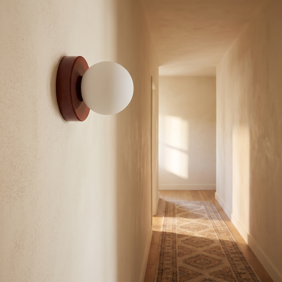 Ulla wall sconce in Red on a hallway wall in afternoon light