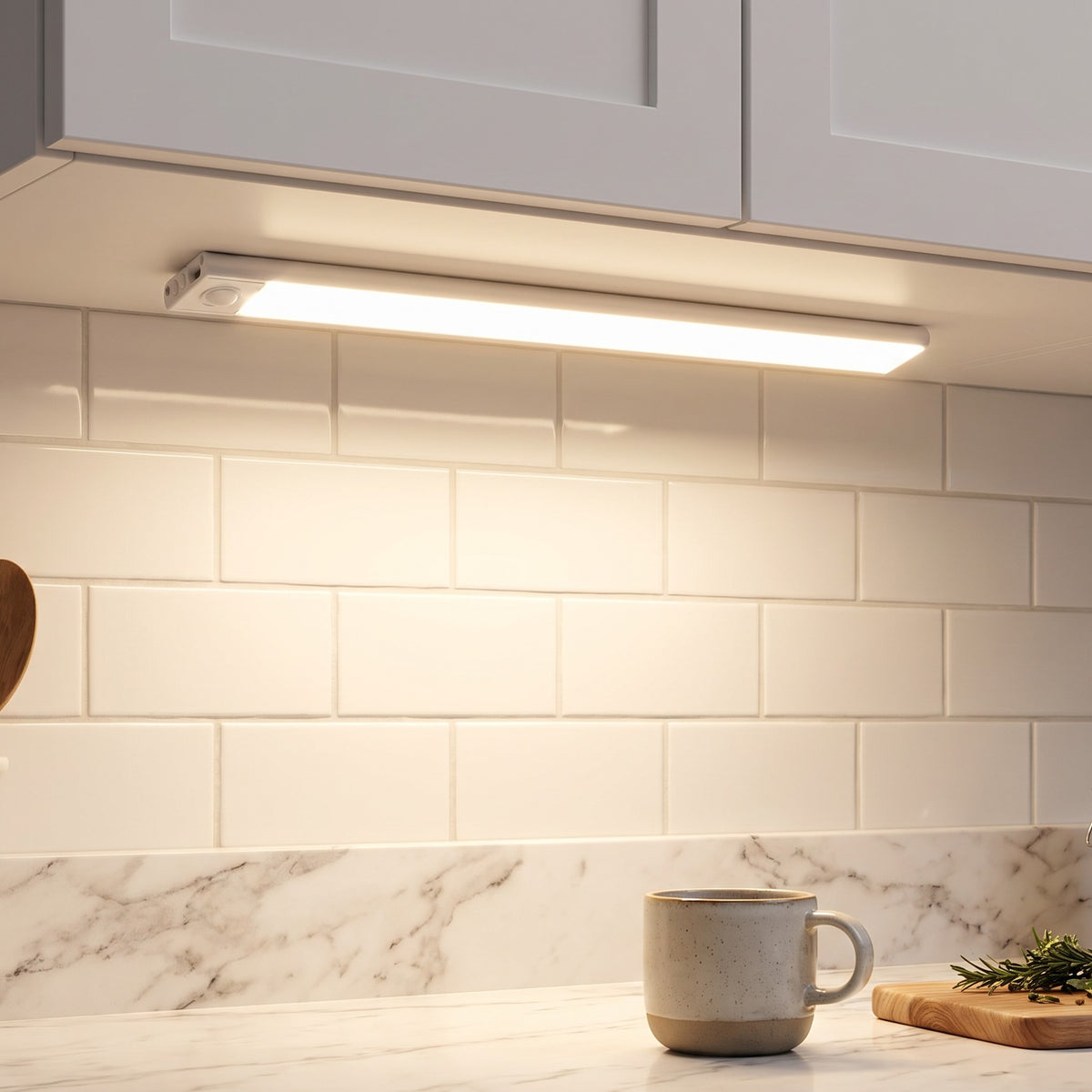 Under Cabinet Light in Silver under a kitchen cabinet above a marble counter