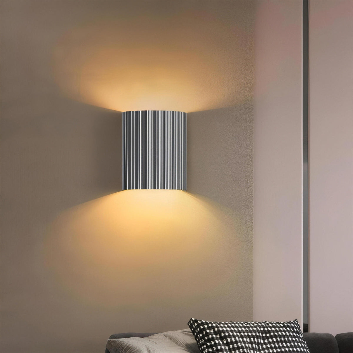 Gray Unni LED wall sconce lit above and below