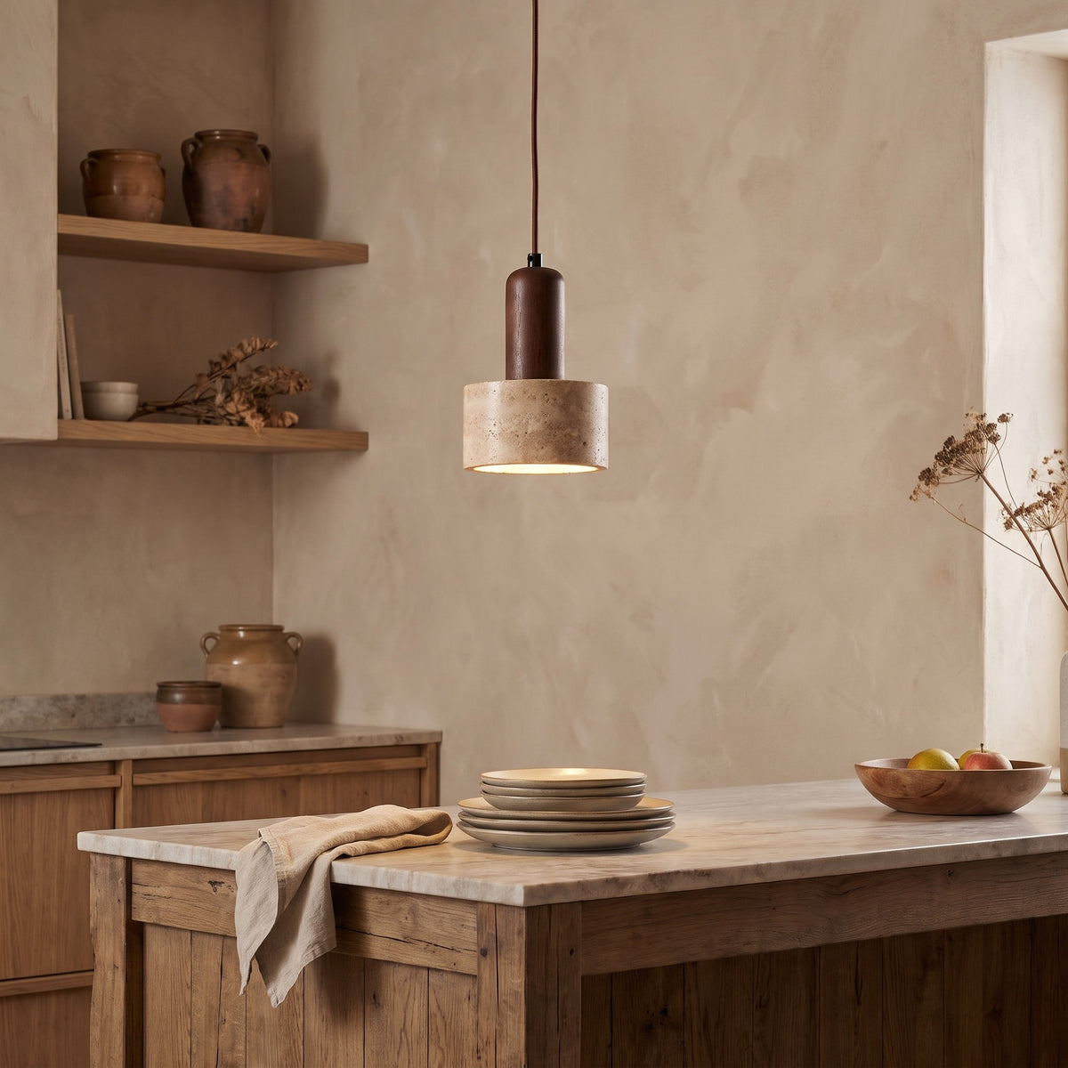 Vanja travertine pendant light lit over a kitchen counter