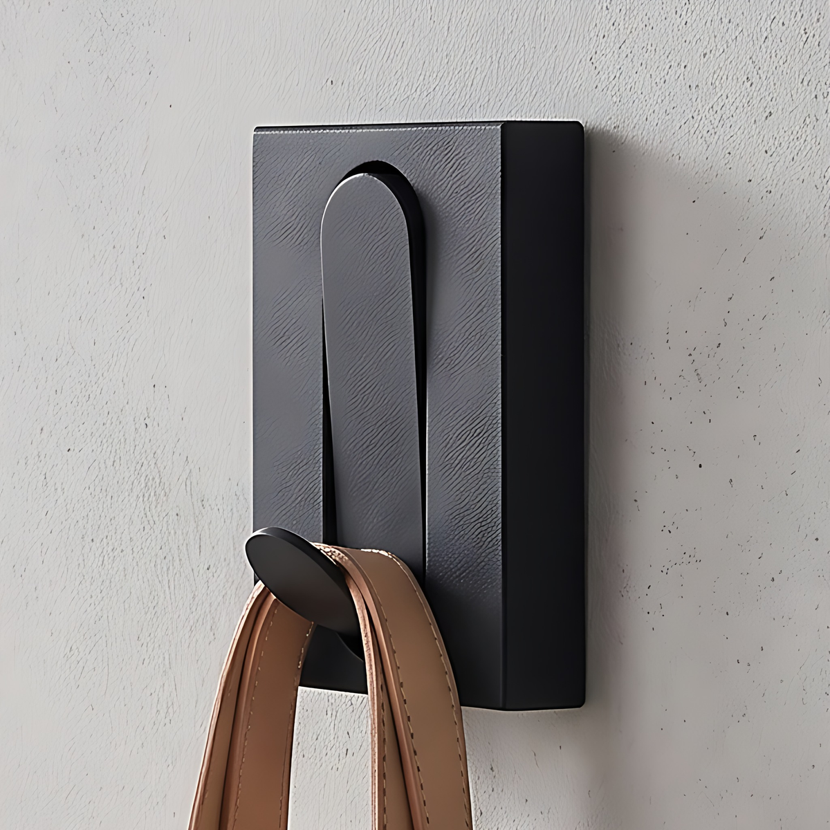 Black wall hook, 1 hook, 2", on a warm plaster wall