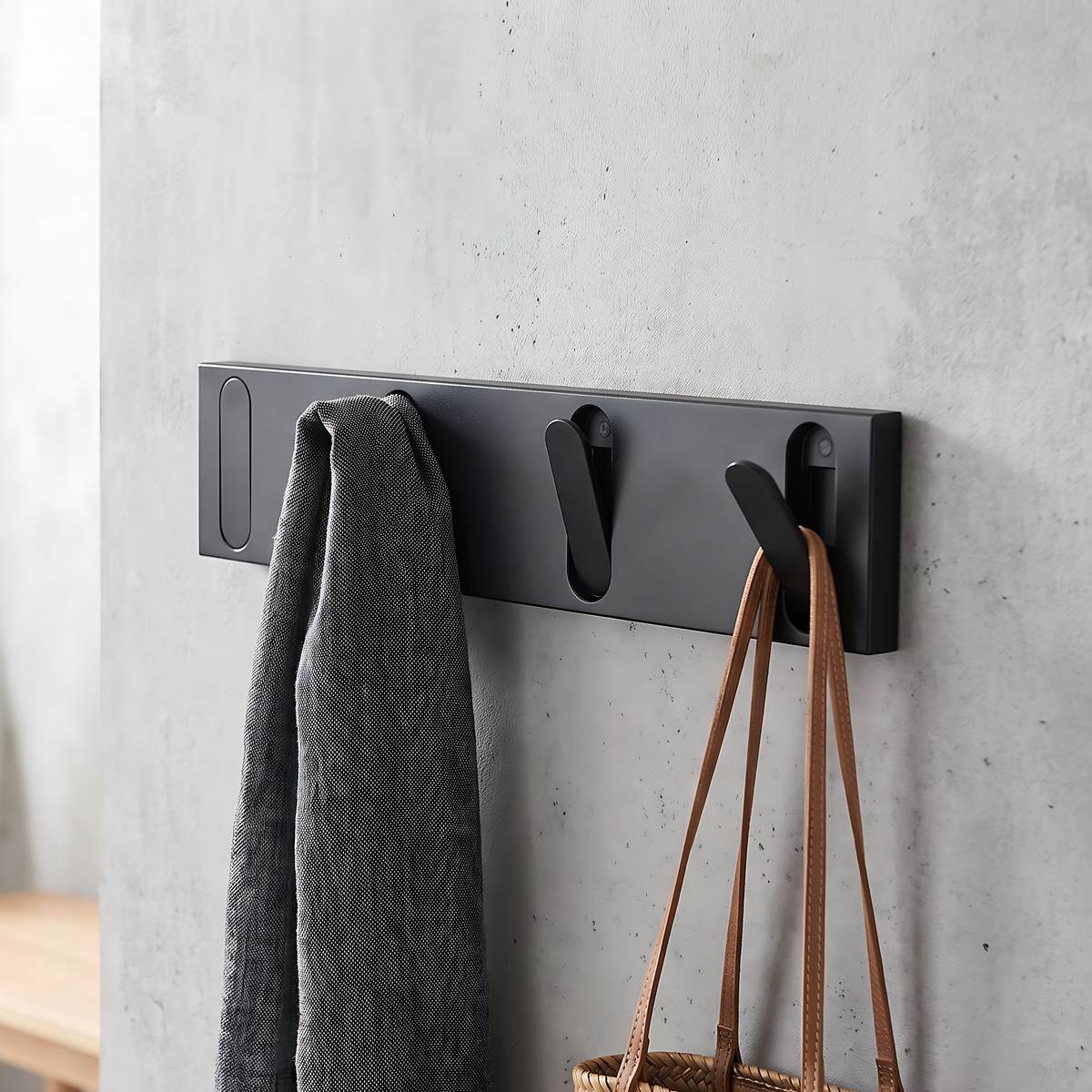 Black wall hook rack, 4 hooks, 12.6", on a warm plaster wall
