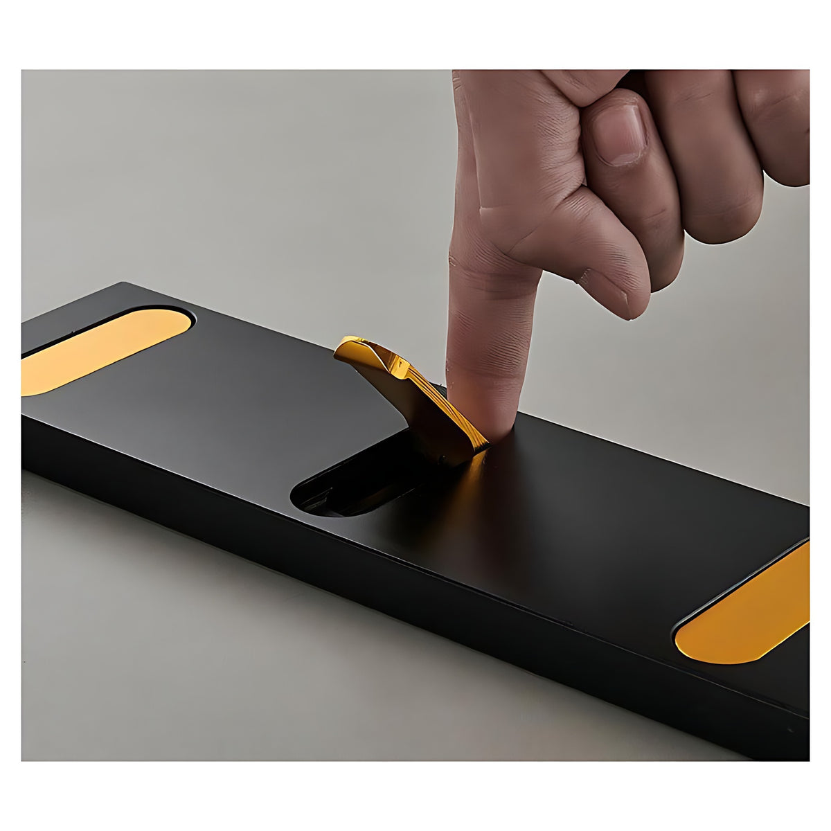 Gold hook flipping out of the black aluminum bar