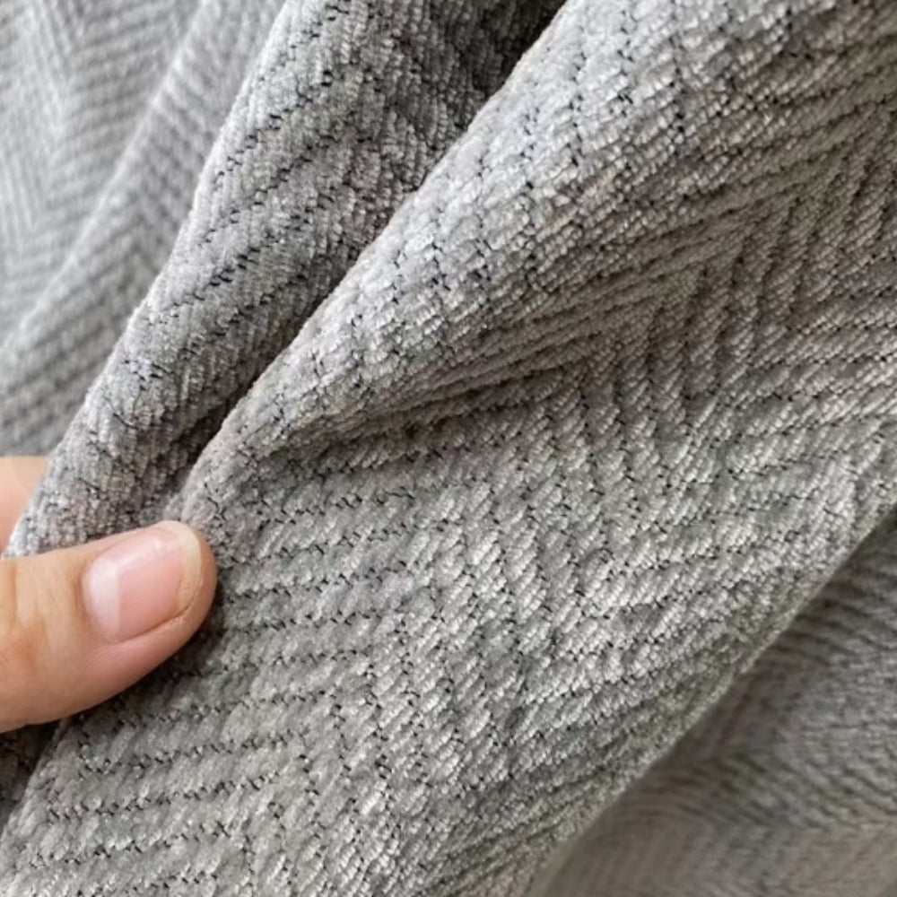 Close view of the gray chenille weave pinched between two fingers