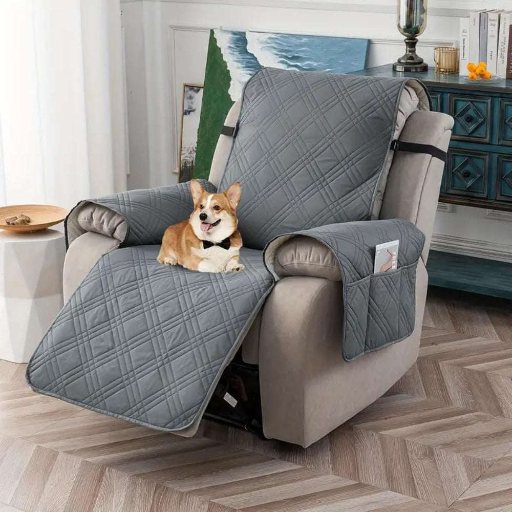 Gray waterproof recliner cover on a recliner in a living room with a small dog sitting on the seat