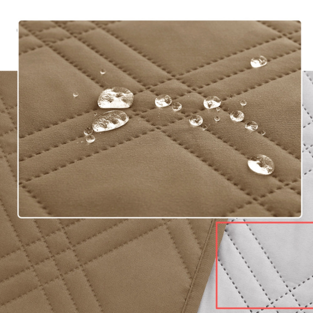 Close view of water beading on the beige quilted surface of the recliner cover