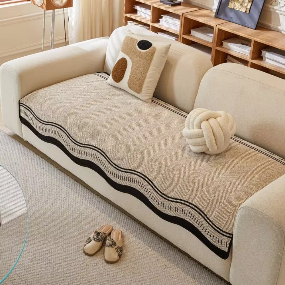 Beige wave edge seat cover on the seat of a cream sofa seen from the front